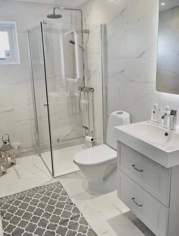 Finished bathroom renovation with a walk-in glass shower and new vanity unit